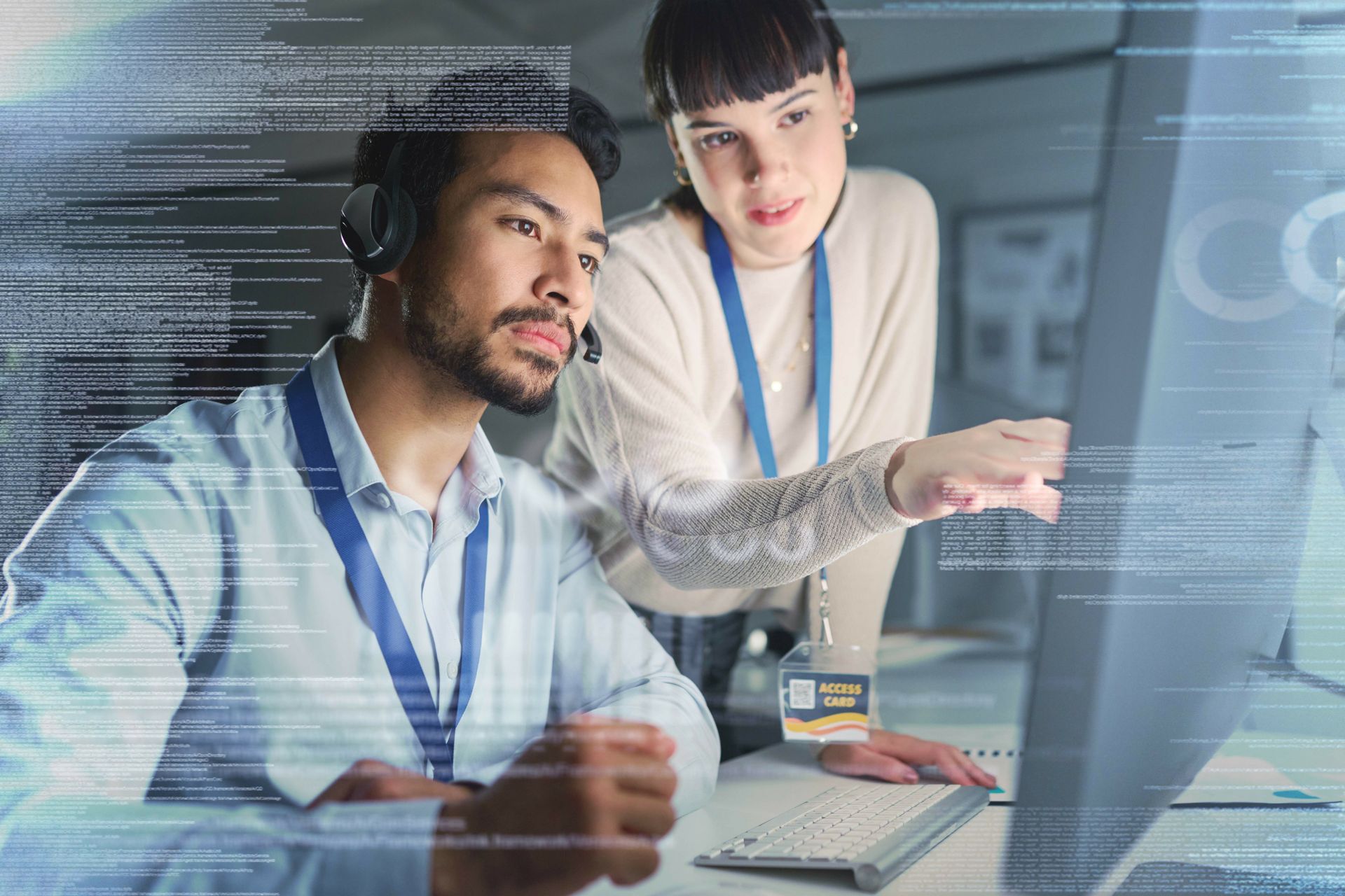 A man and a woman are looking at a computer screen.