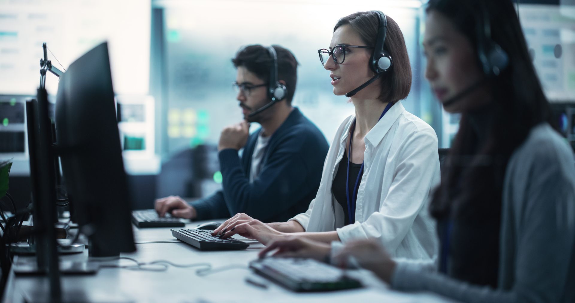 A group of people are working in a call center.