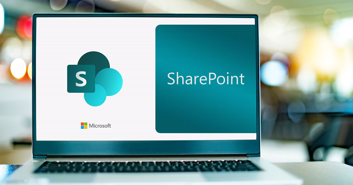 A laptop computer is open to a screen that says sharepoint.