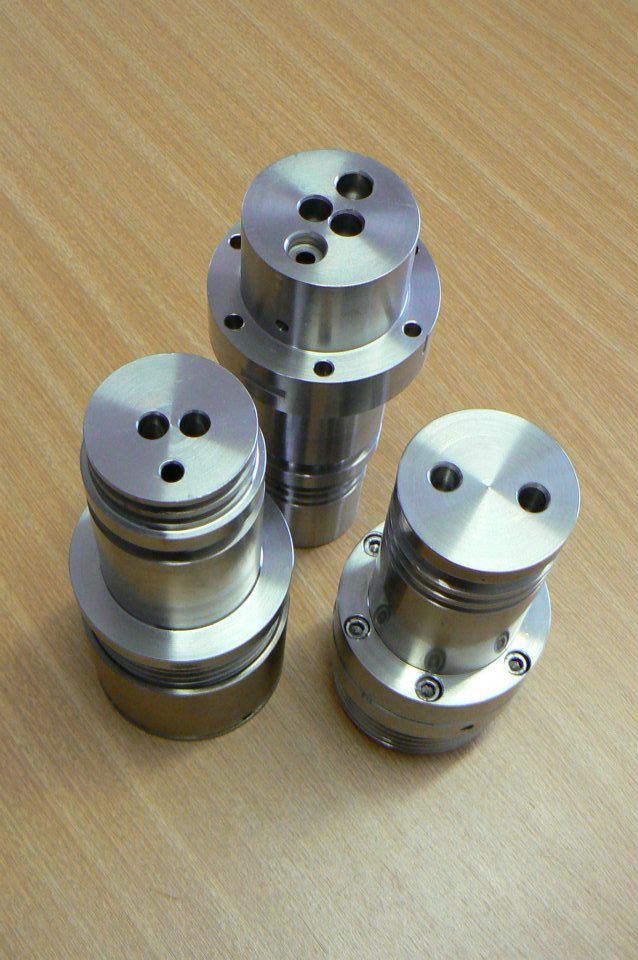 Three Metal Pieces Are Stacked On Top Of Each Other On A Wooden Table — D.E.M Solutions Pty Ltd In Caboolture, QLD