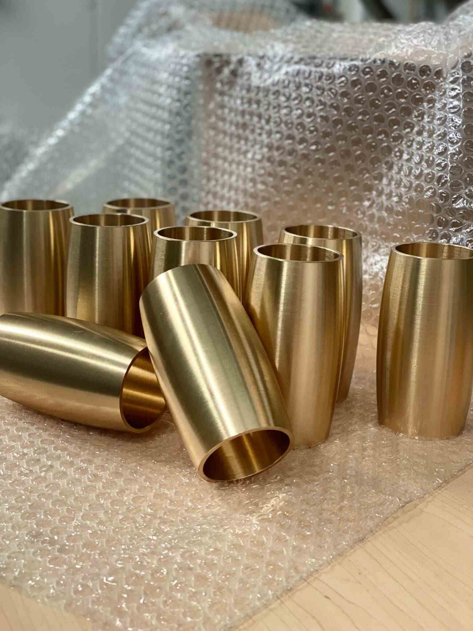 A Bunch Of Brass Cups Sitting On Top Of A Table — D.E.M Solutions Pty Ltd In Caboolture, QLD