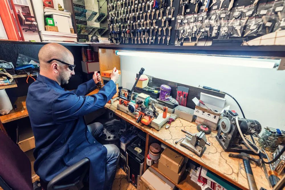 A Man is Sitting at a Desk Working on a Computer — Eddie Williams Locksmiths in Palm Cove, QLD