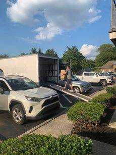 Truck parked on street with vibrant orange sunset and palm trees in the background.