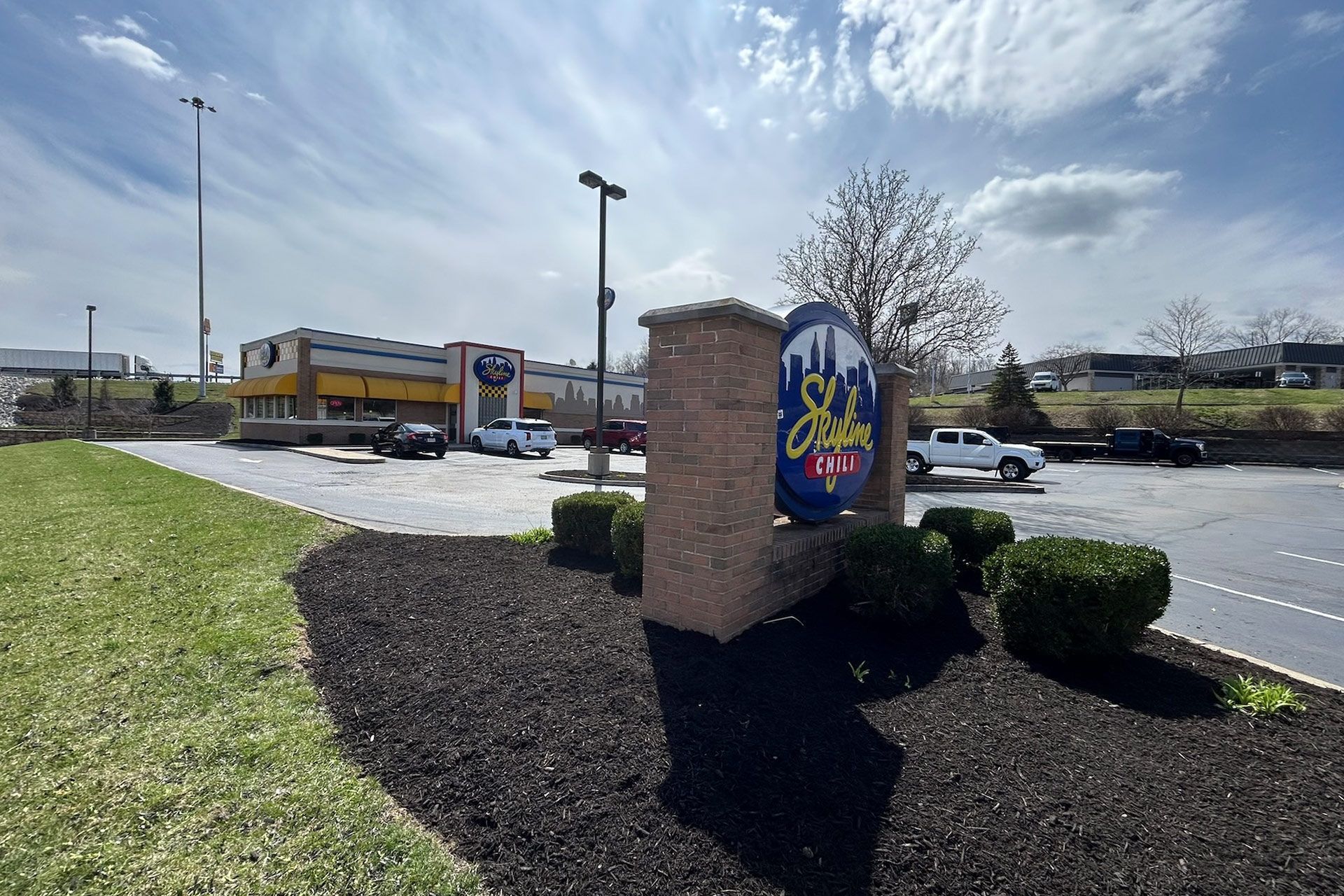 Sign for City Barbeque with building in background. Sunny day, exterior shot.