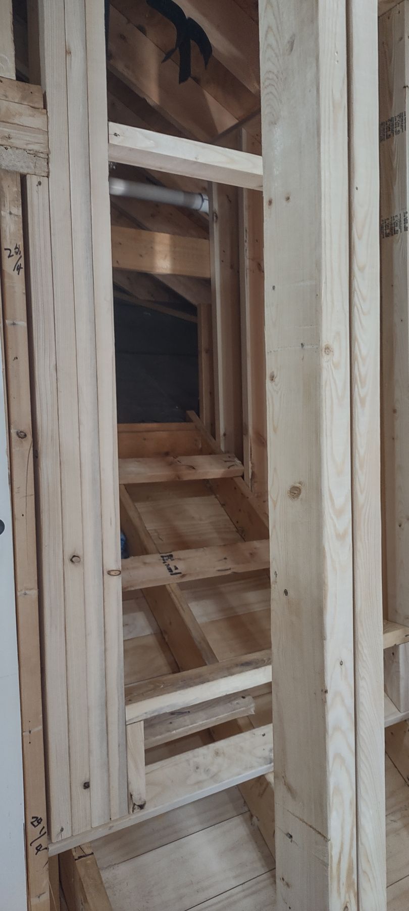 Wooden frame of a staircase under construction.