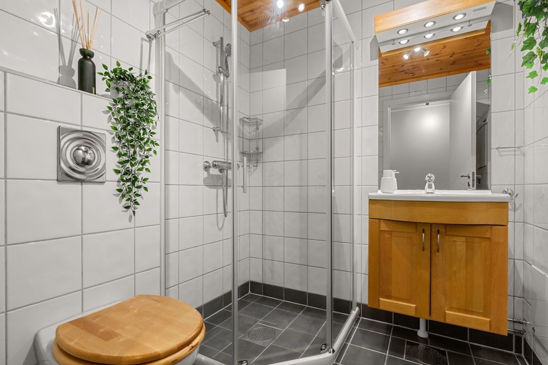 A sleek dual-flush toilet and a low-flow showerhead - Sustainable bathroom materials