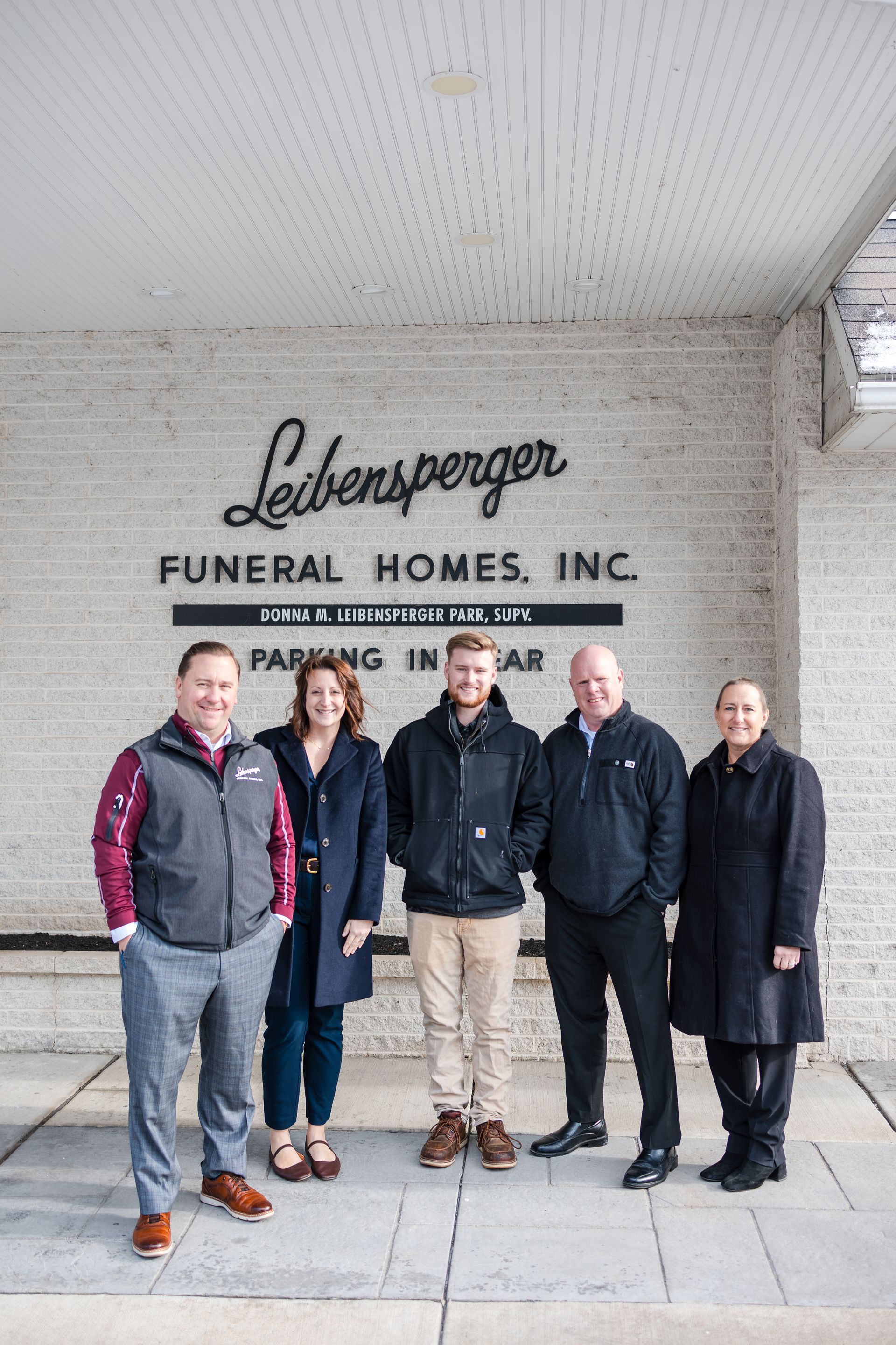 Church building with a white peaked roof against a blue sky.