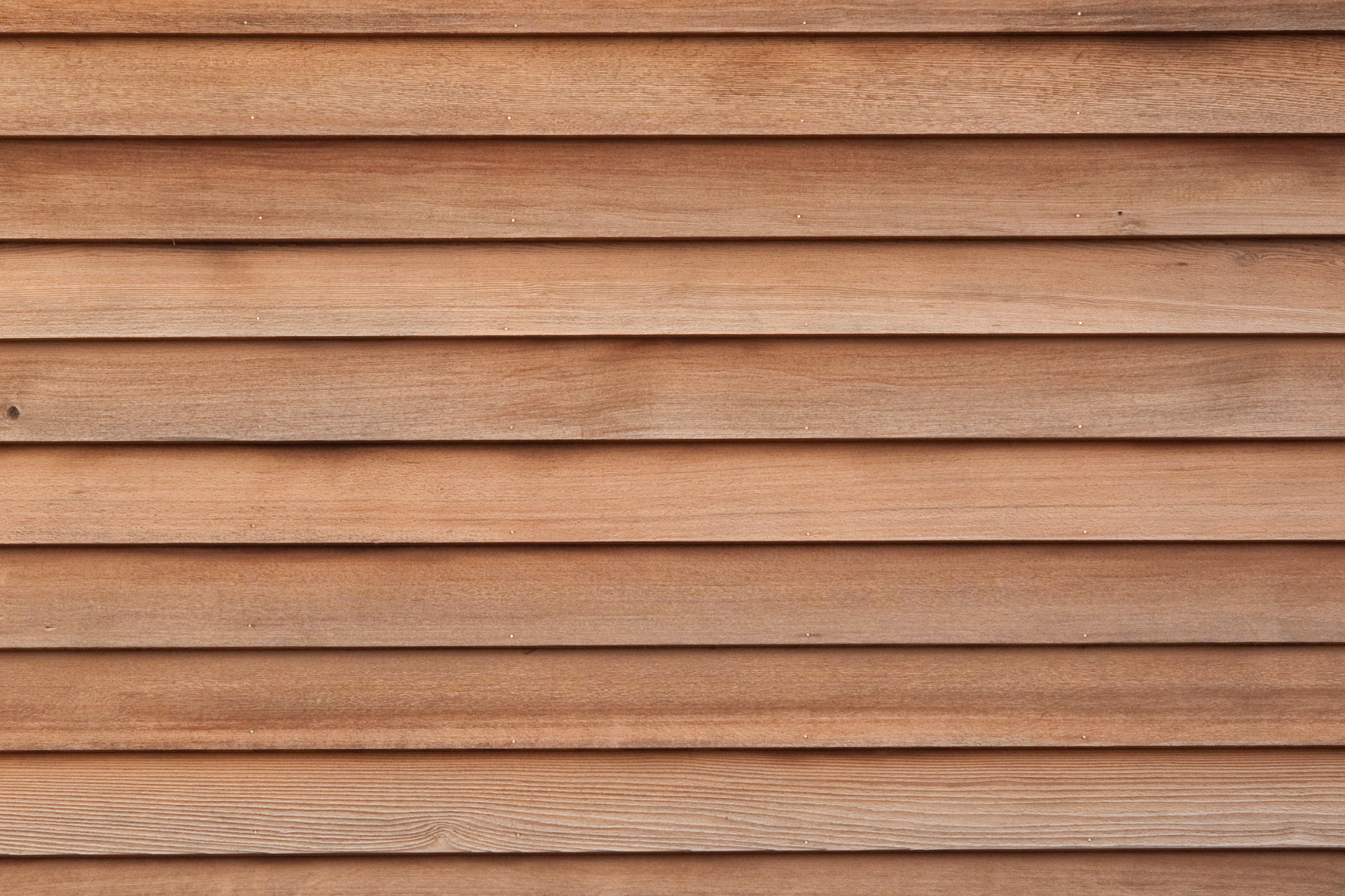 A close up of a wooden siding on a house.