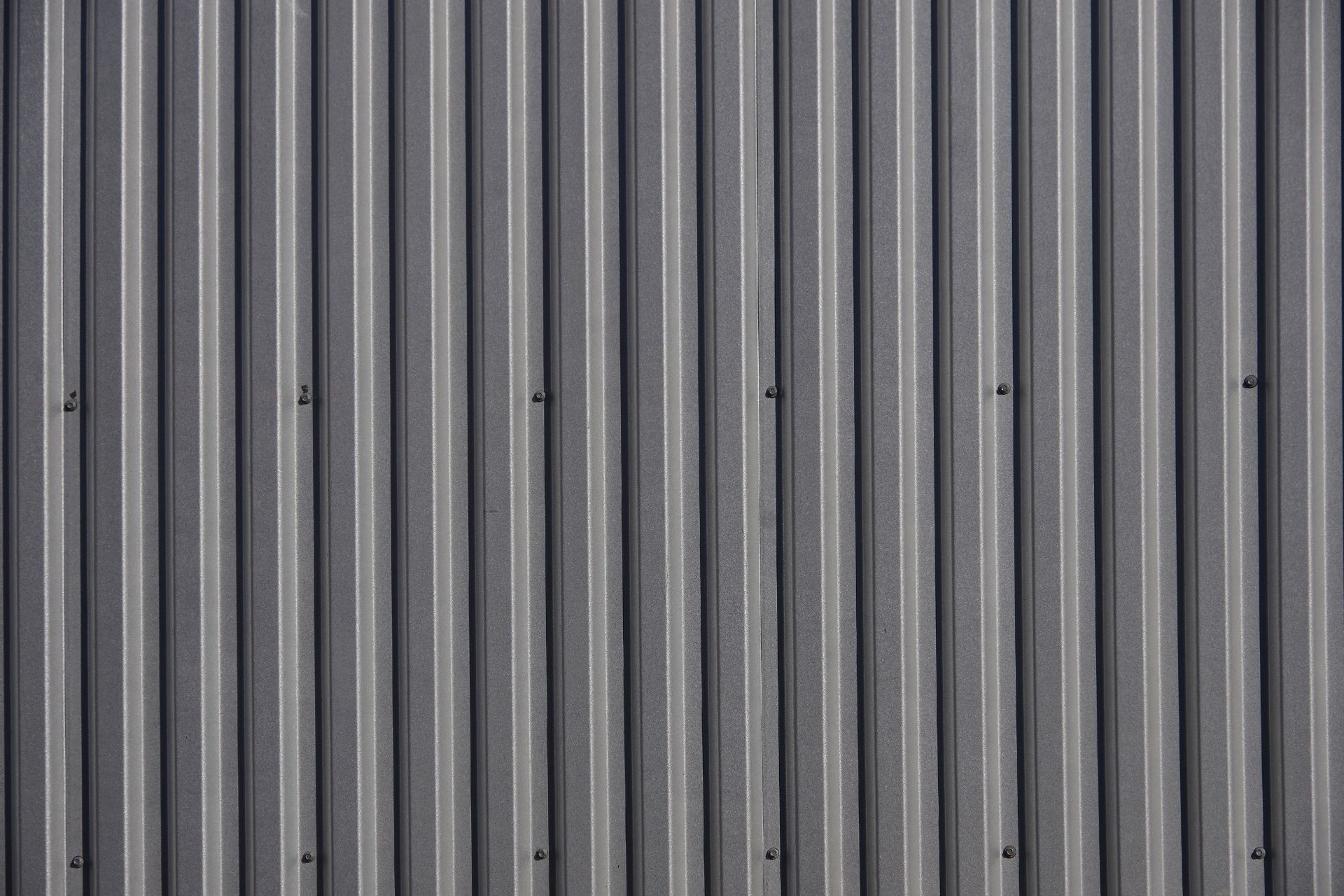 A close up of a gray corrugated metal wall.