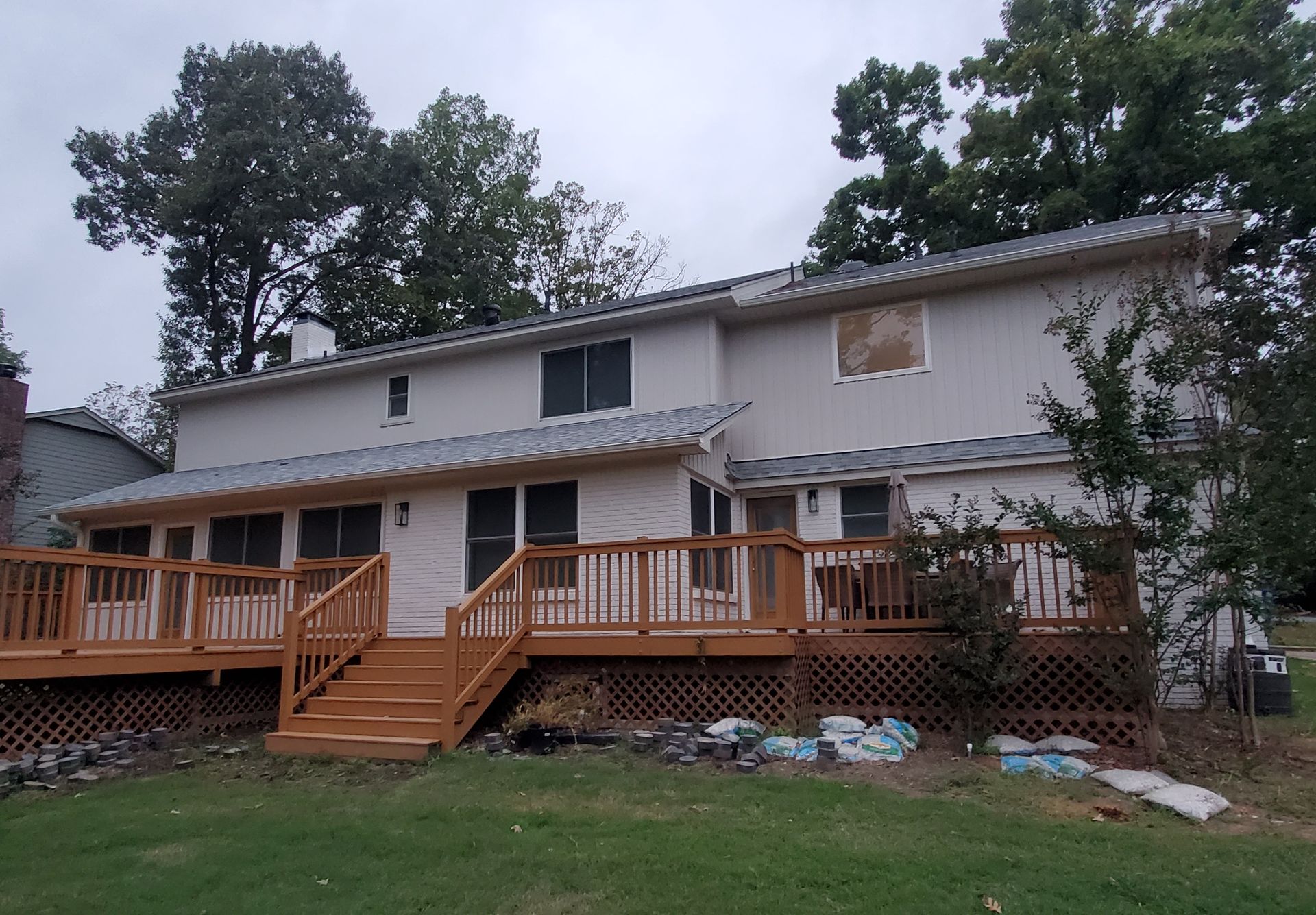 Exterior Portfolio Board & Batten vinyl siding in Bone. 5” seamless gutters, downspouts, and all trim in Linen
