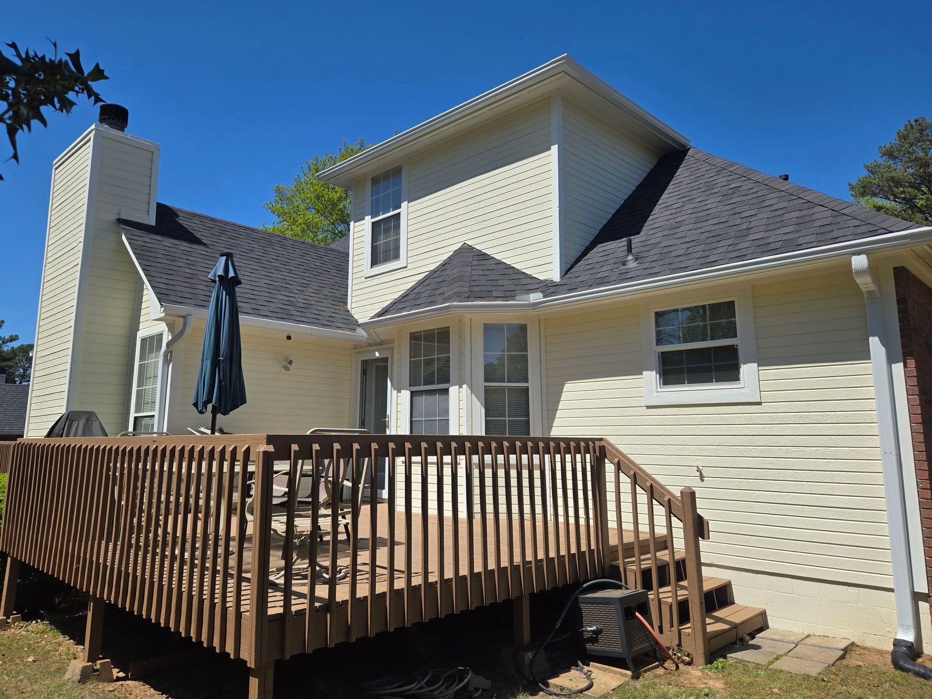 CertainTeed Landmark architectural in Moire Black. 6” seamless gutters and downspouts in white. House painted in Sherwin Williams ‘Morning Sun’. All trim painted in Sherwin Williams ‘Westhighland White’