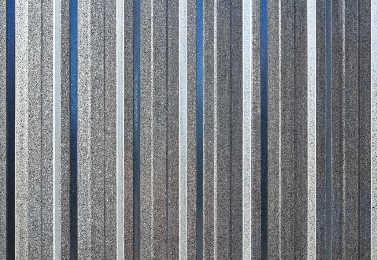 A close up of a gray corrugated metal wall.