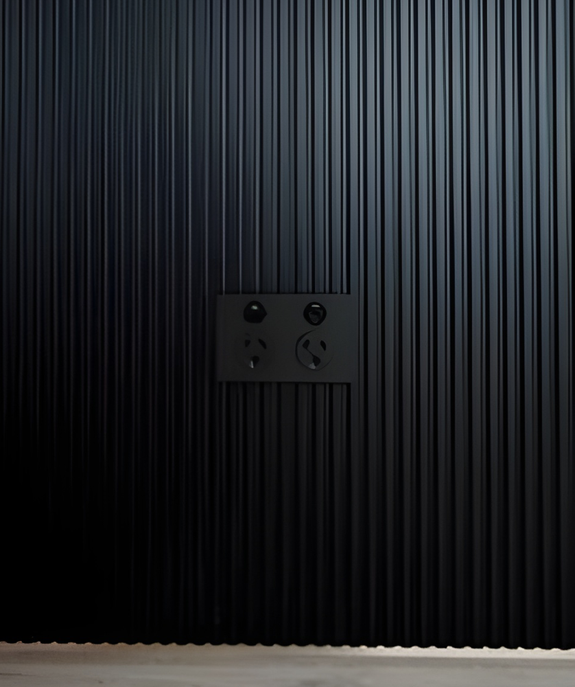 Black Ridged Wall with Matching Outlet Panel — Rapid Sparky in Dapto, NSW