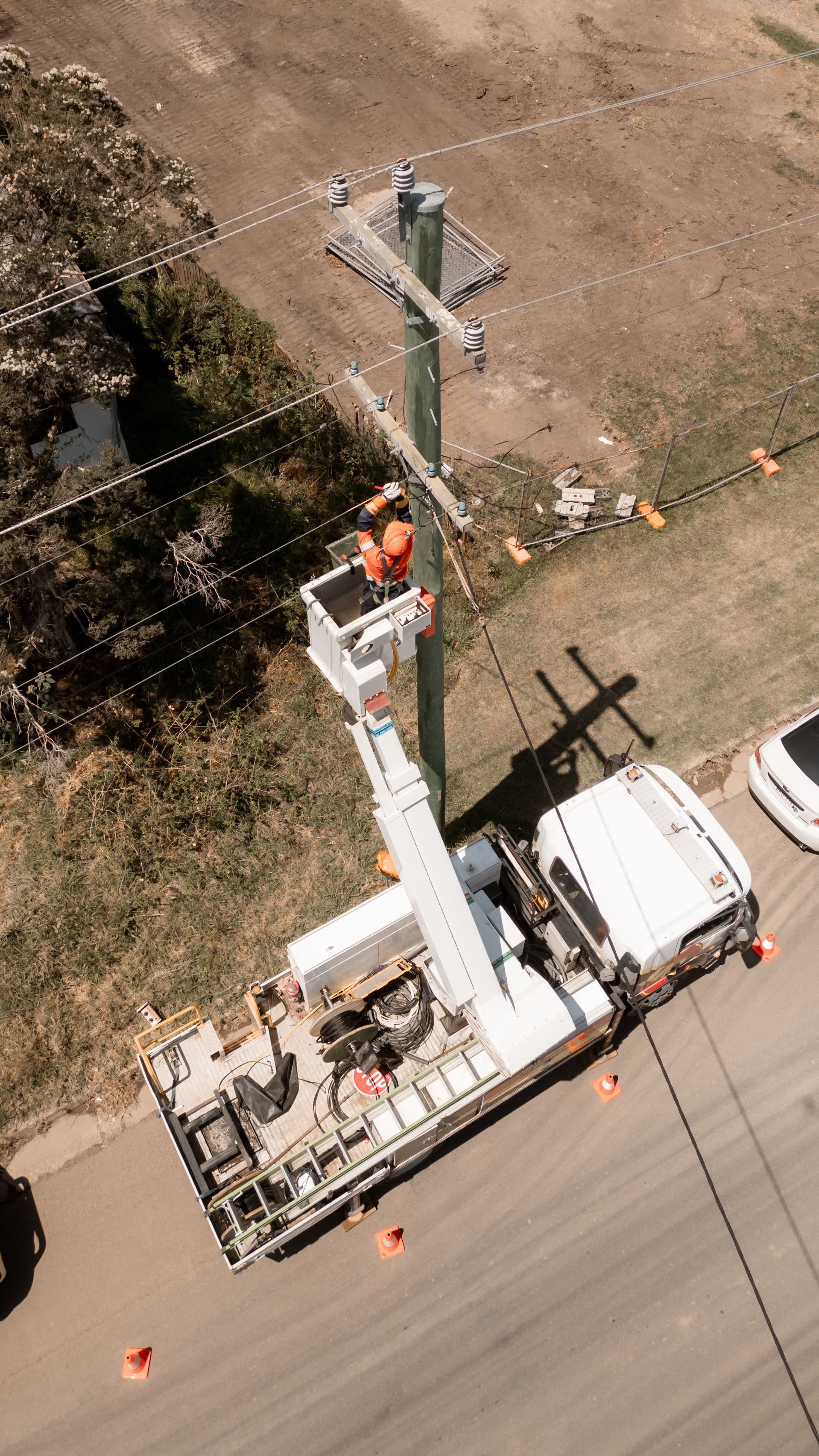 A man is being lifted up to work on electrical wires — Rapid Sparky in Kiama, NSW