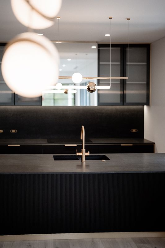 A Kitchen With Black Cabinets , a Sink and a Faucet — Rapid Sparky in Dapto, NSW
