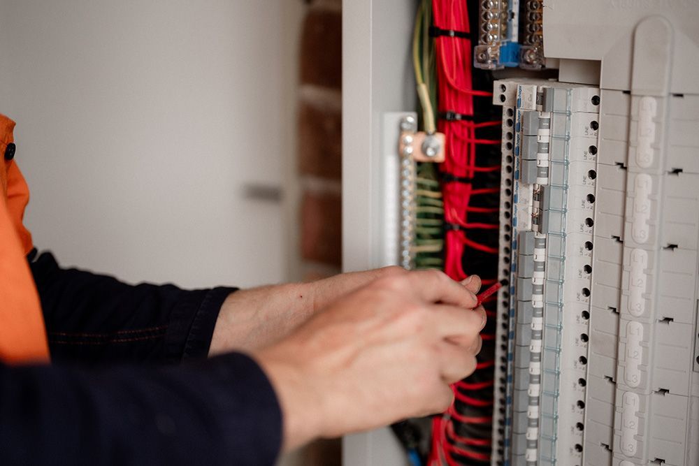 A Person is Working on an Electrical Box With a Screwdriver — Rapid Sparky in Dapto, NSW 
