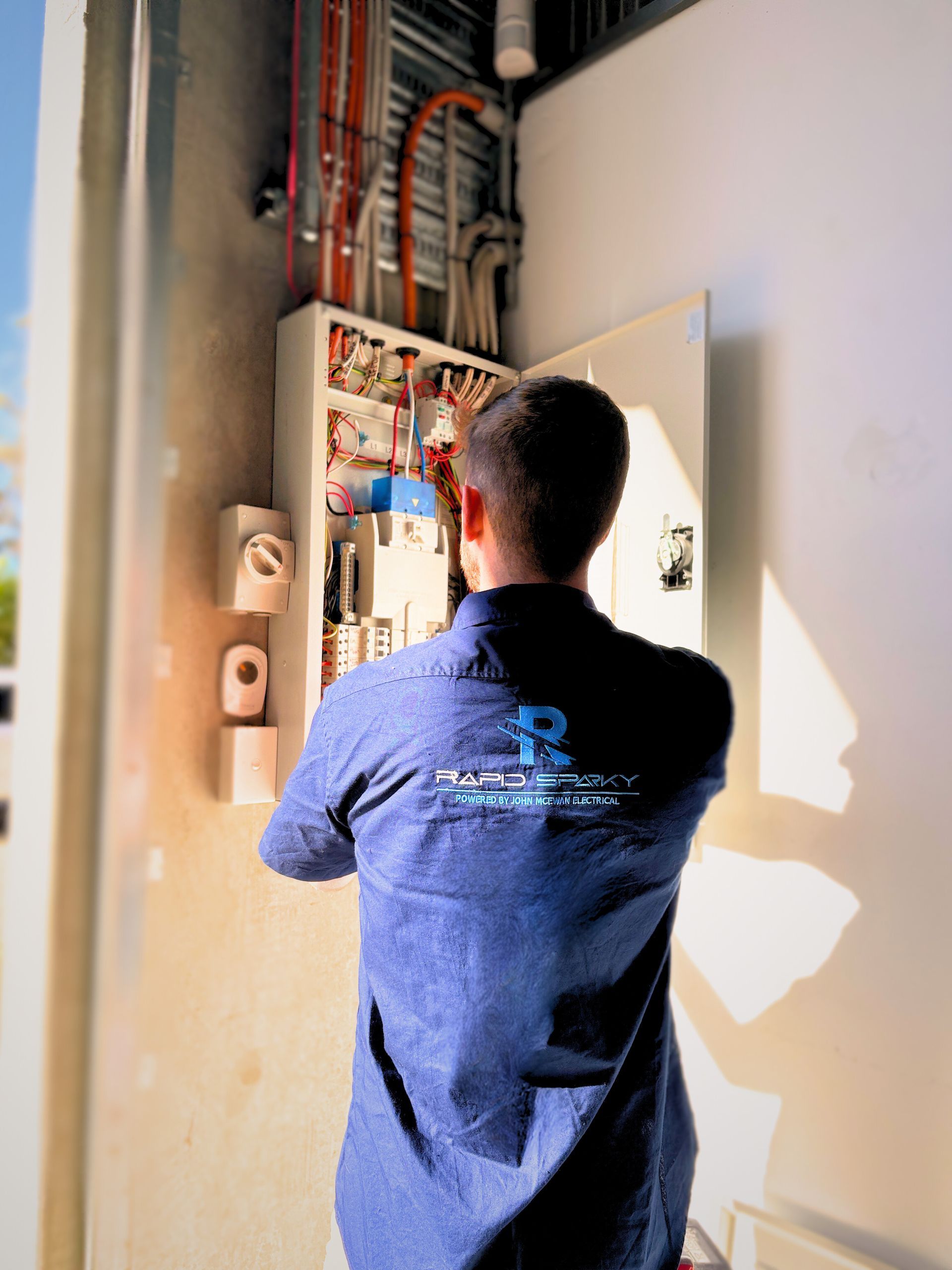an electrician is working on a switchboard — Rapid Sparky in Dapto, NSW