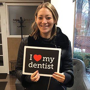 Woman holding a sign that says