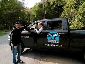 Two men by a black truck with