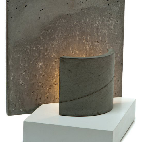 A concrete sculpture with a light inside of it
