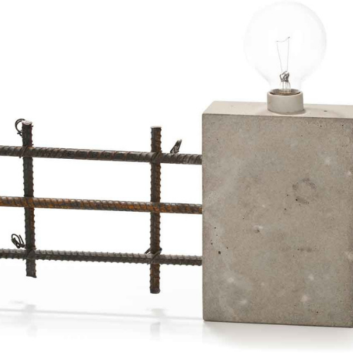A light bulb is sitting on top of a concrete block