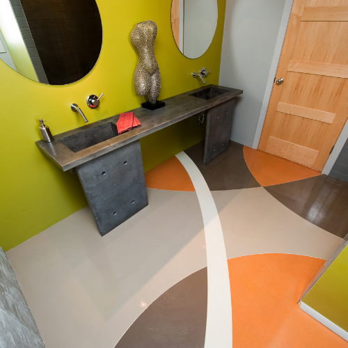 A bathroom with a concrete sink and a mirror on the wall