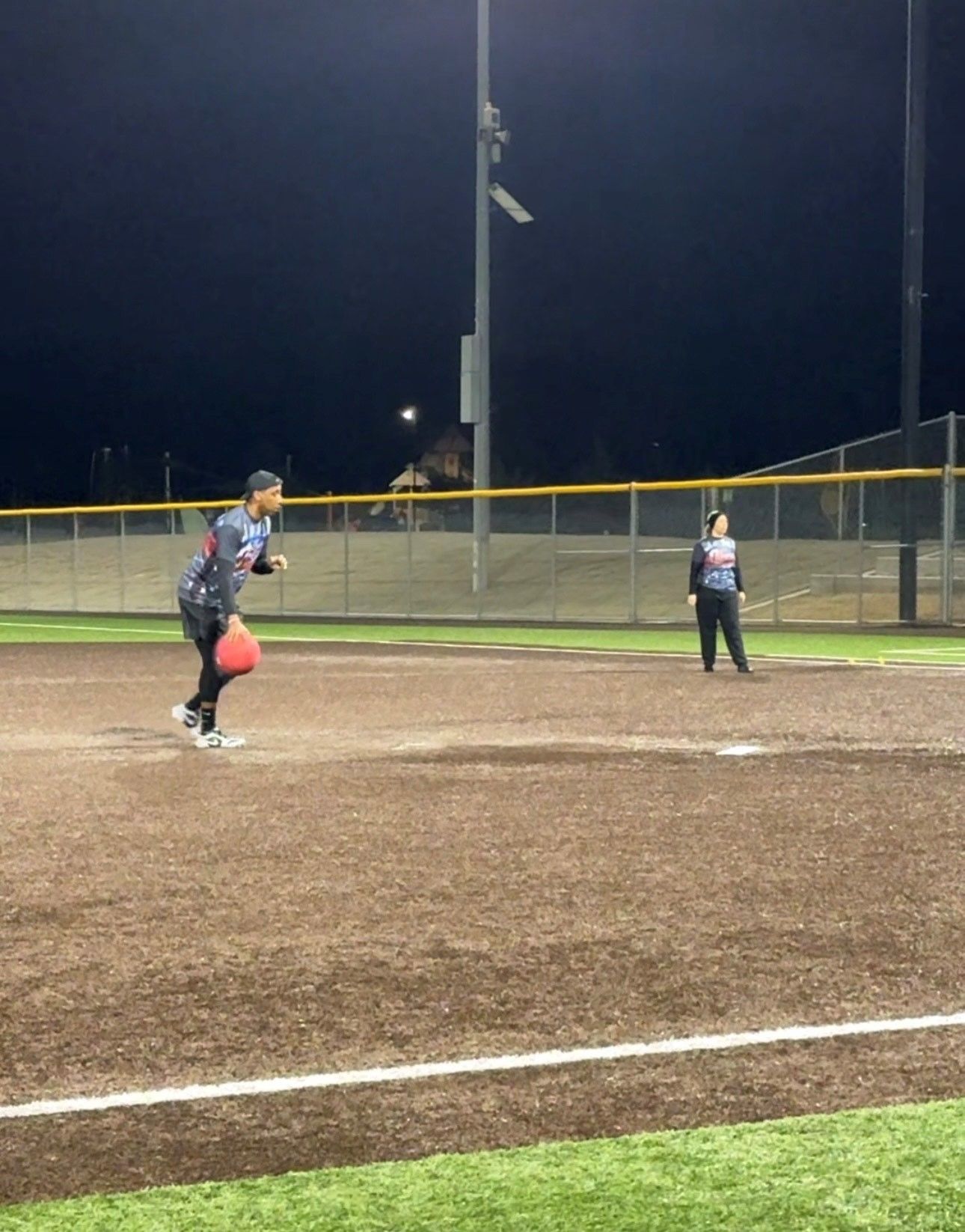 Pitcher rolling the ball to home during a kickball game