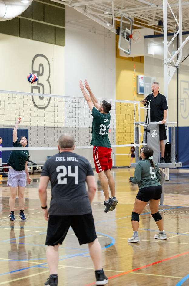 Man attempting to block the ball during a volleyball game at STRC.