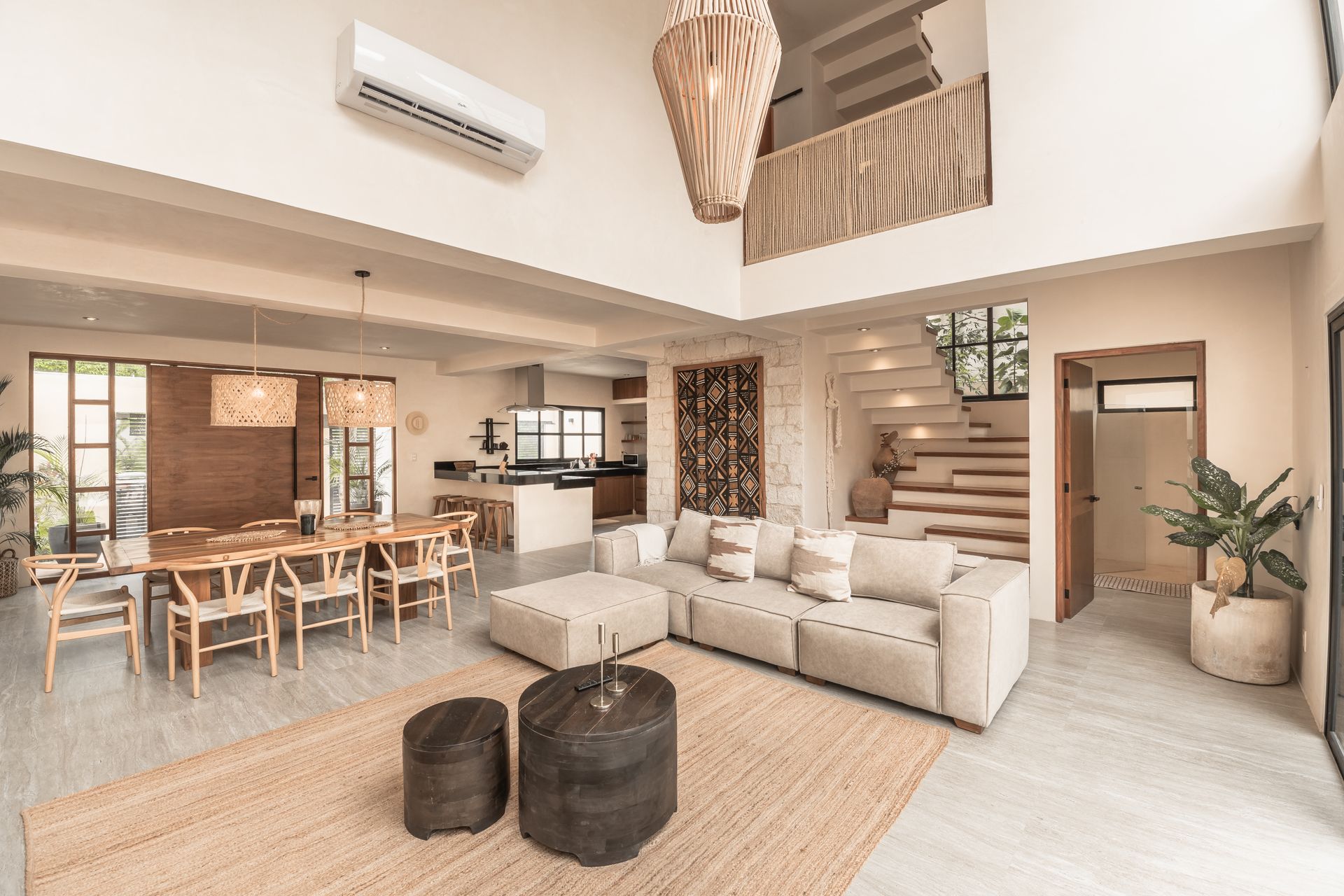 A living room with a couch , table , chairs and a rug.