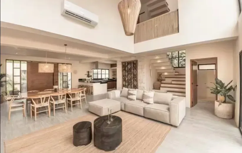 A living room with a couch , table and chairs.