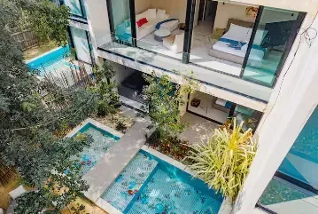 An aerial view of a house with a swimming pool and a bedroom.