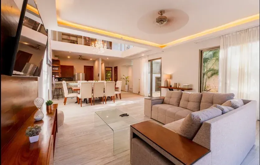 A living room with a couch , table , and television.