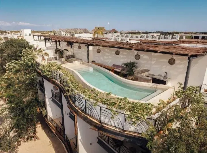 An aerial view of a large swimming pool on top of a building.