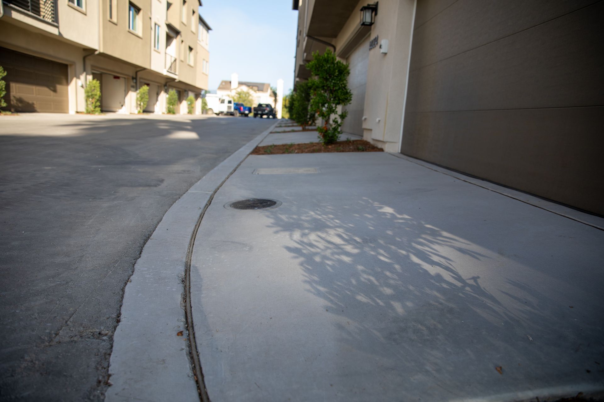 A corner of a street with a manhole cover on it