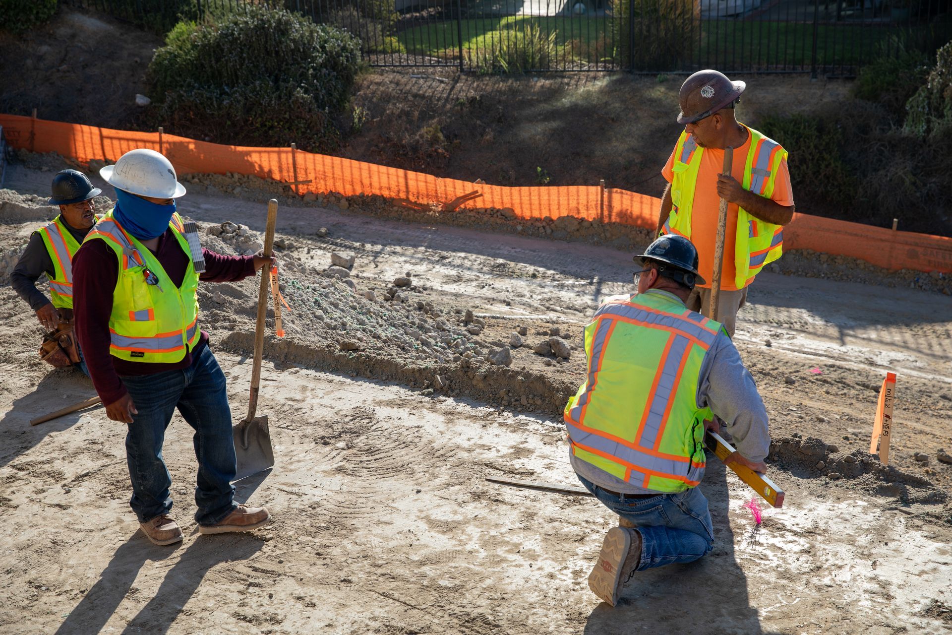 A group of construction workers are working on a road.
