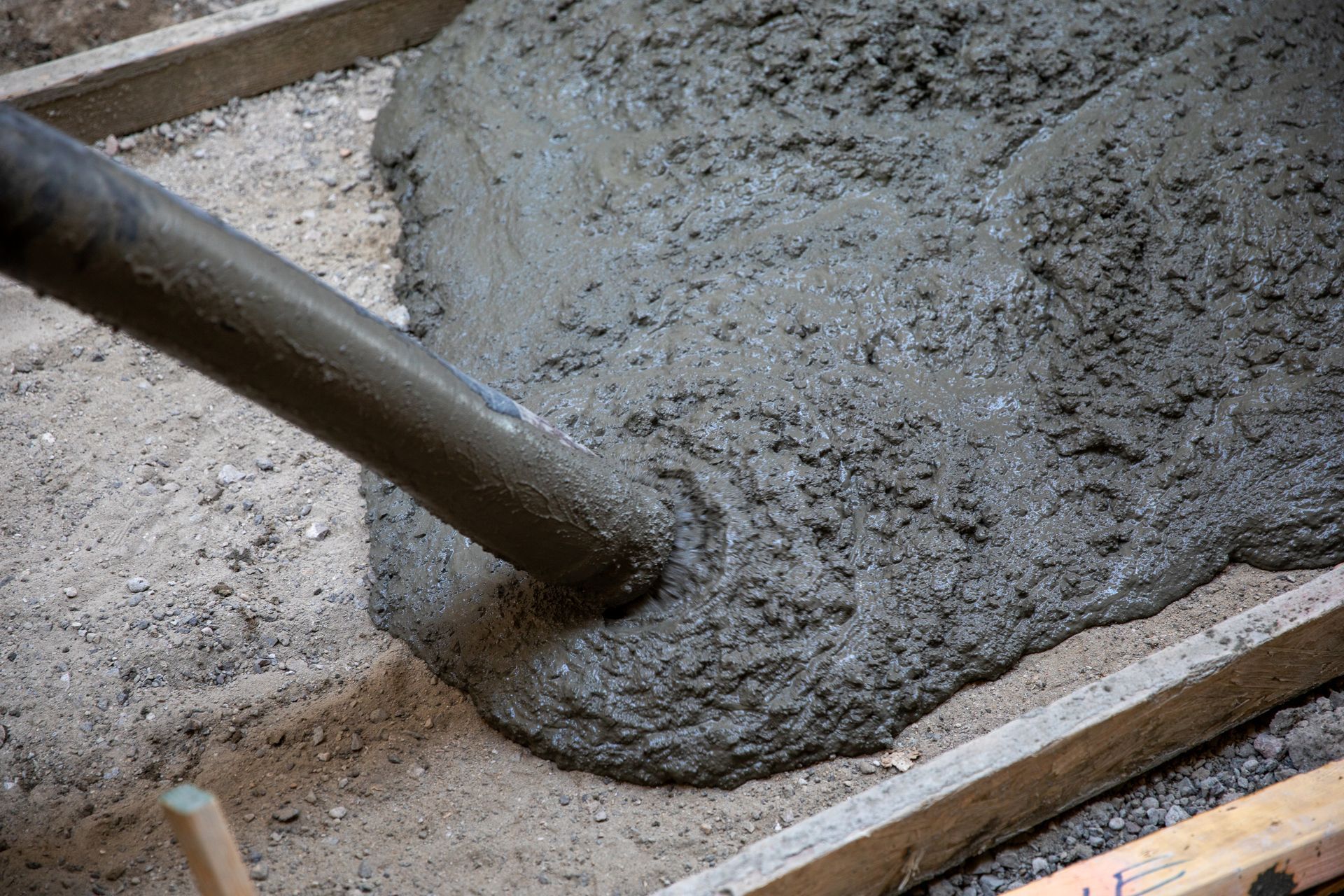A concrete pump is being used to pour concrete into a concrete slab.