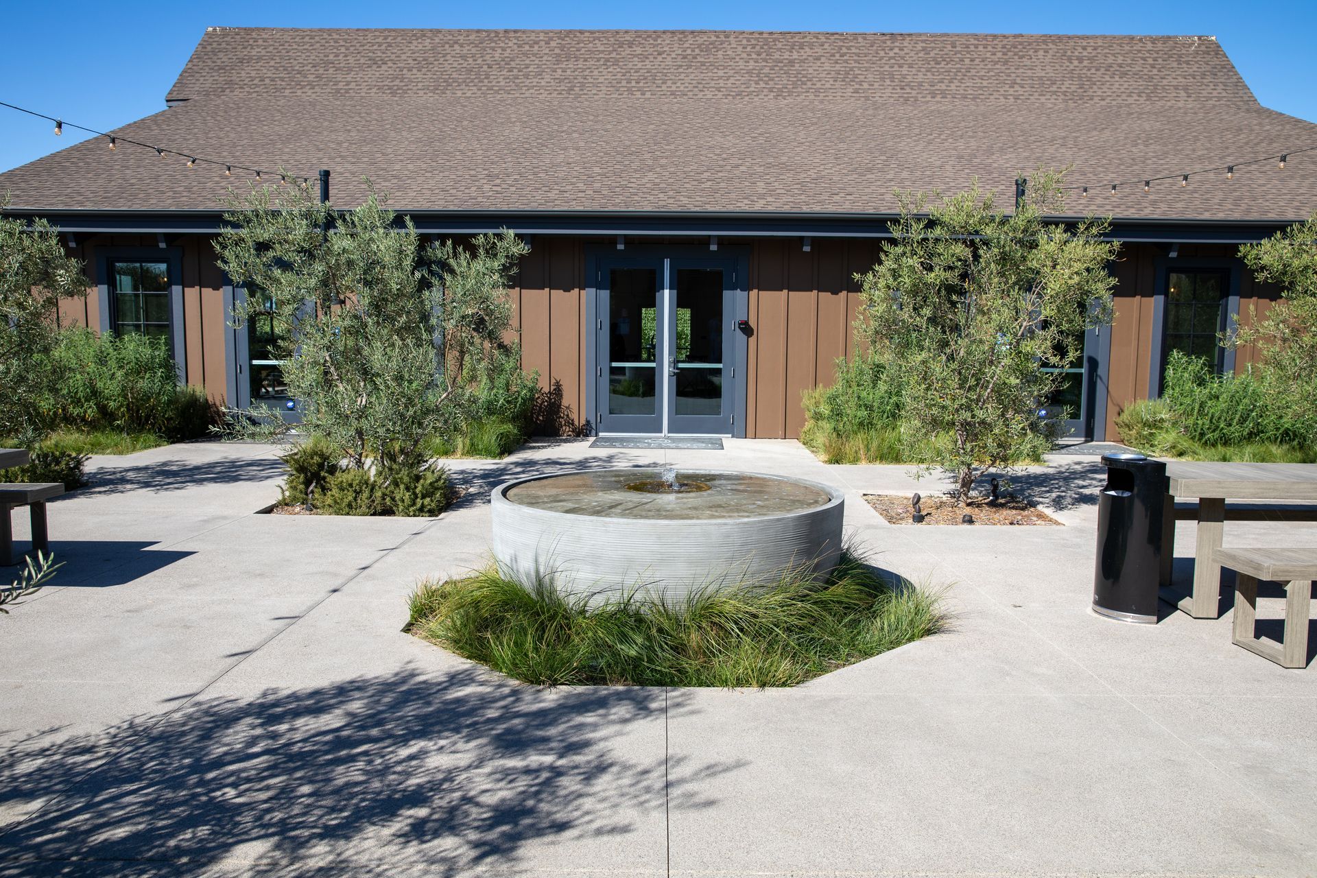 A house with a fountain in front of it