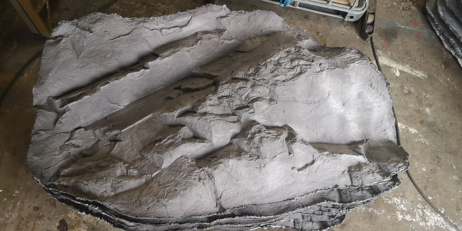 A large piece of concrete is sitting on the ground.