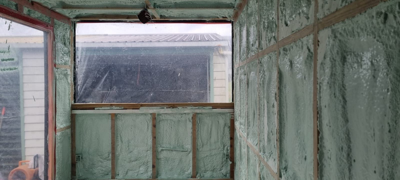A room with a lot of foam on the walls and a window.