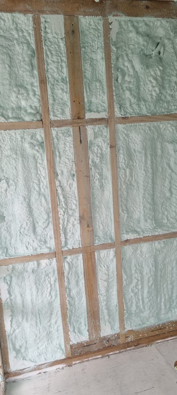 A wall with a lot of foam on it and a wooden frame.