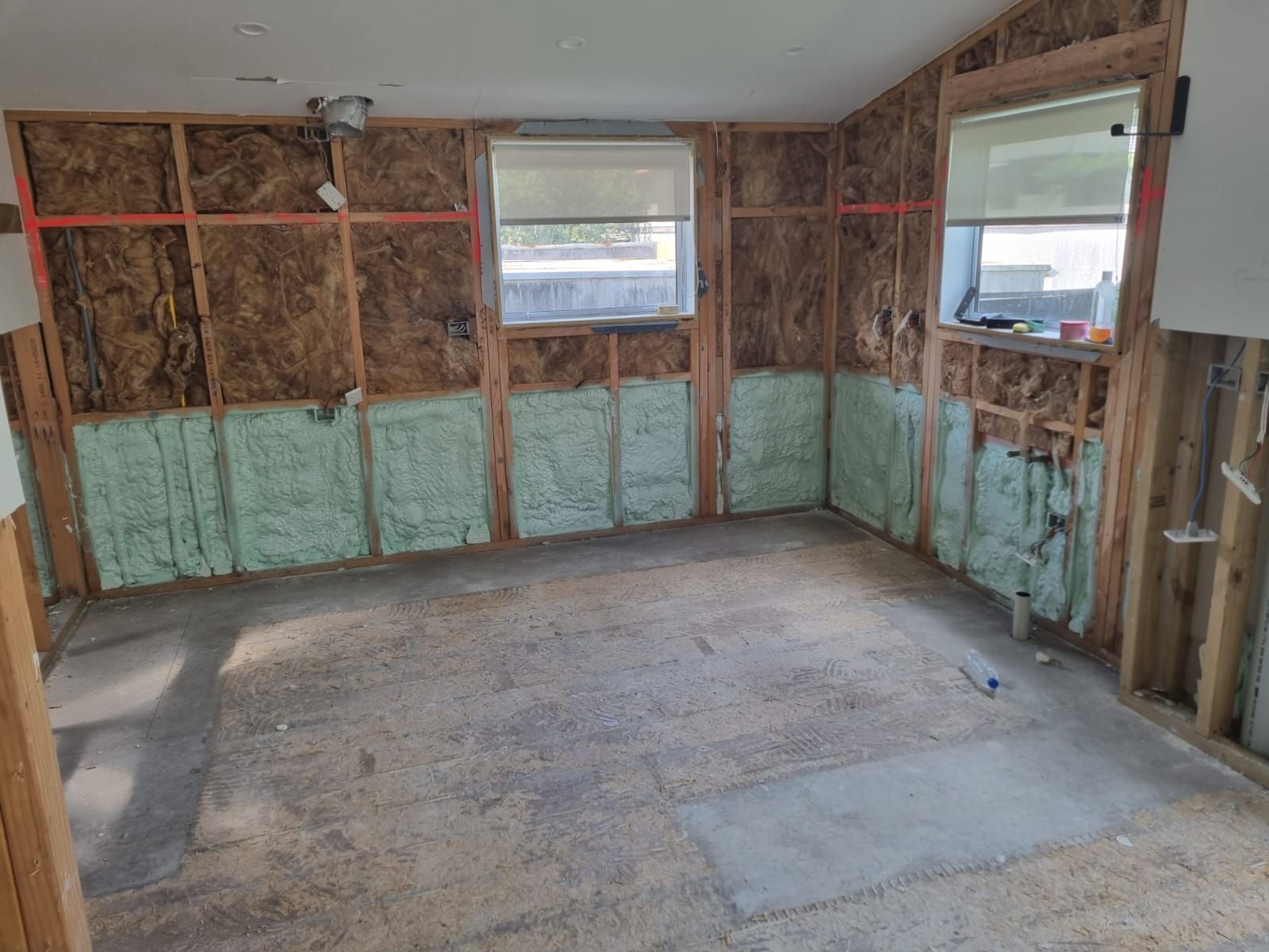 A room with a lot of insulation on the walls and a window.