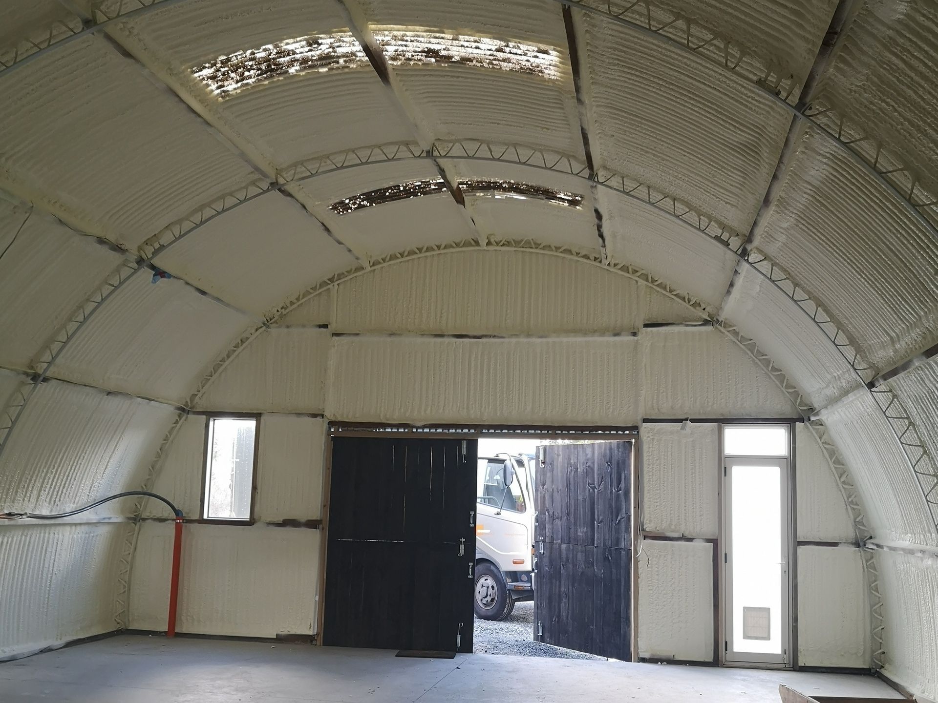 An empty room with a truck parked in the doorway