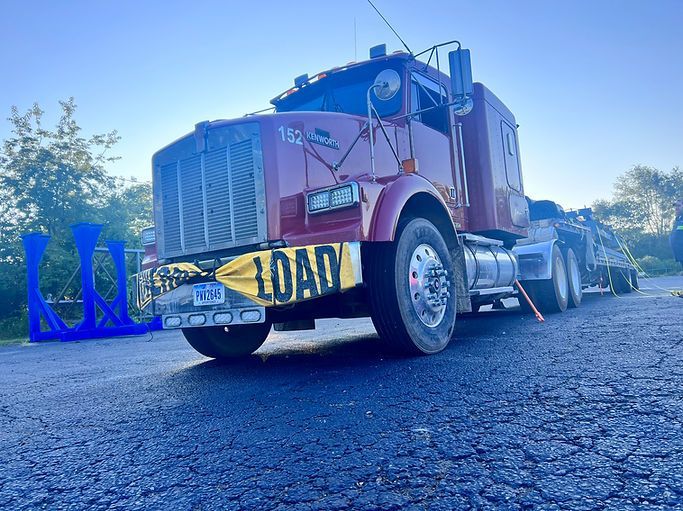 A red semi-truck is parked on the side of the road