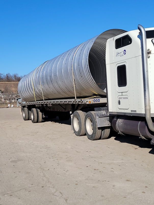 Semi-Truck is Carrying a Large Pipe