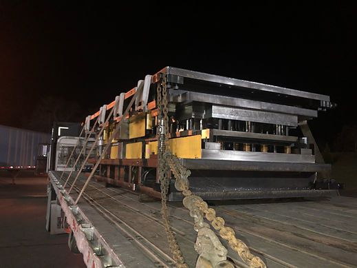 A large piece of metal is sitting on top of a truck