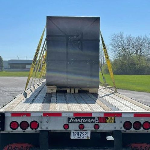 A semi truck with a large box on the back of it