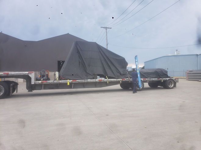 A truck with a tarp on the back of it
