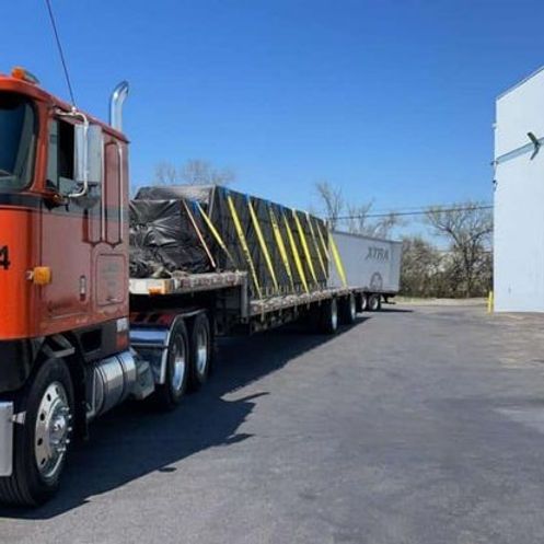 An orange semi truck with the number 4 on it