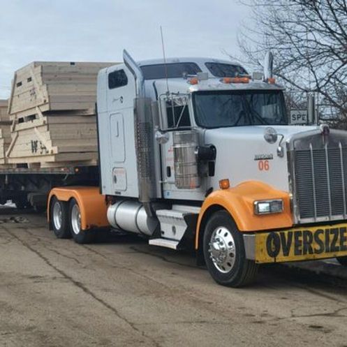 An oversized semi truck is parked in a parking lot