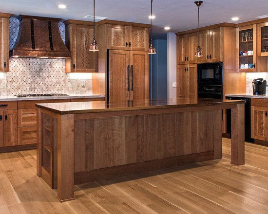 A kitchen with wooden cabinets and a large island